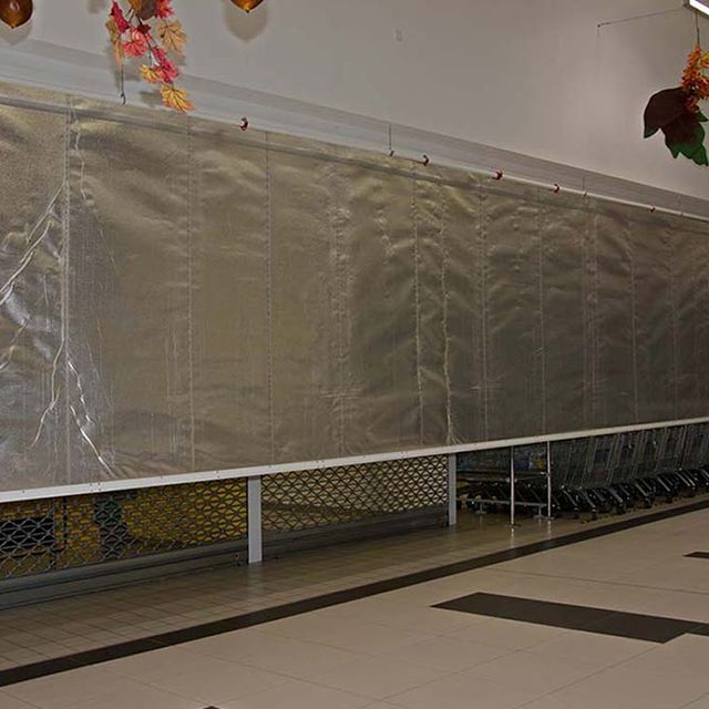 Fire resisting roller curtain